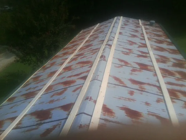 Rusted metal roof panels with new wood purlins before replacement — Storm Damage Roof Repair in Duncannon by Roofing Brothers