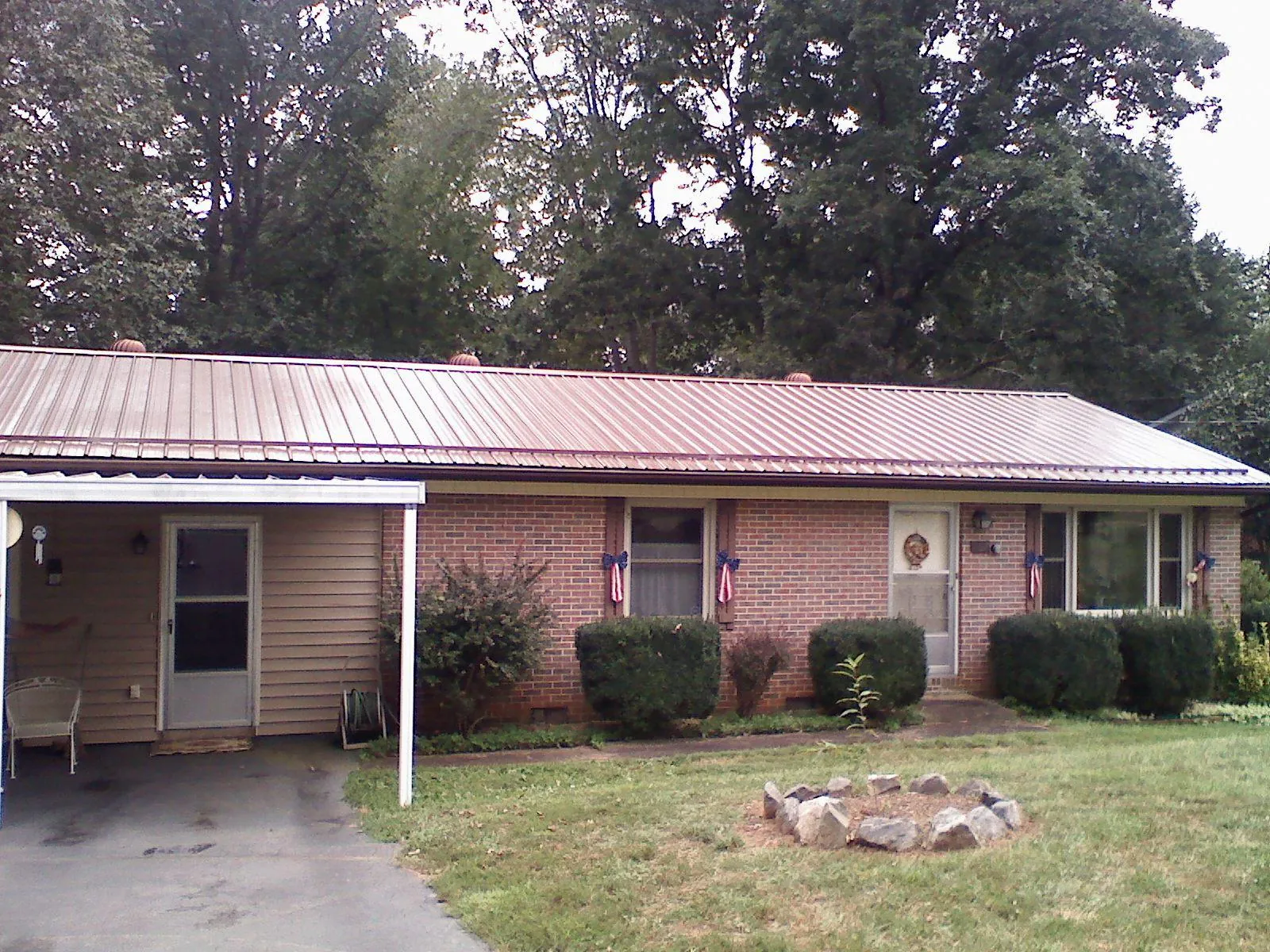 Bronze metal roof and carport on a brick ranch home — Roof Repair work by our crew in Duncannon
